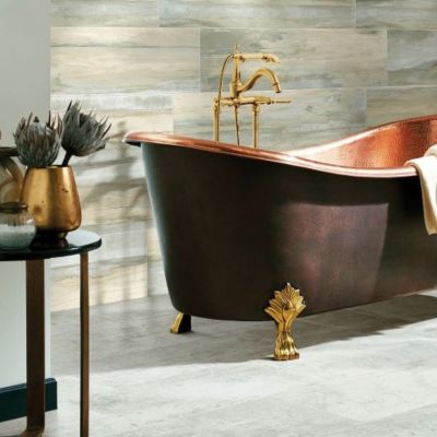 beautiful bathroom remodel with copper tub and wood accent wall and tile floors